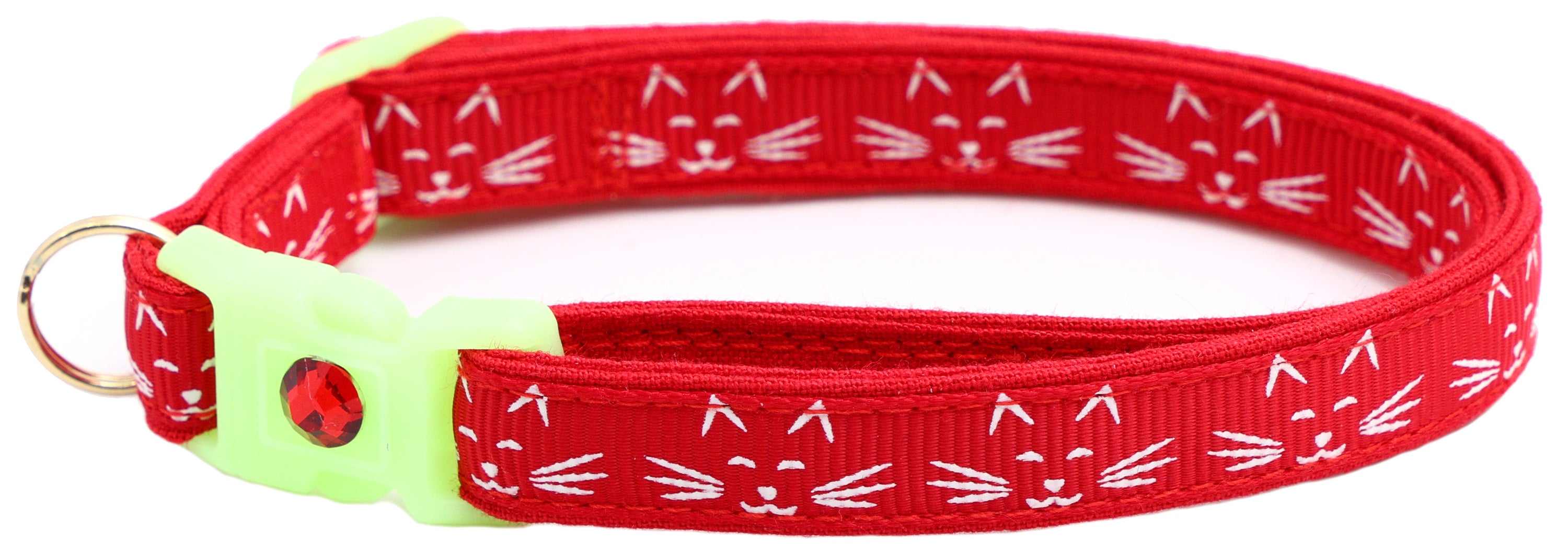 A glowing cat faces breakaway collar made of reinforced cotton, featuring a bell and charm, perfect for nighttime visibility.